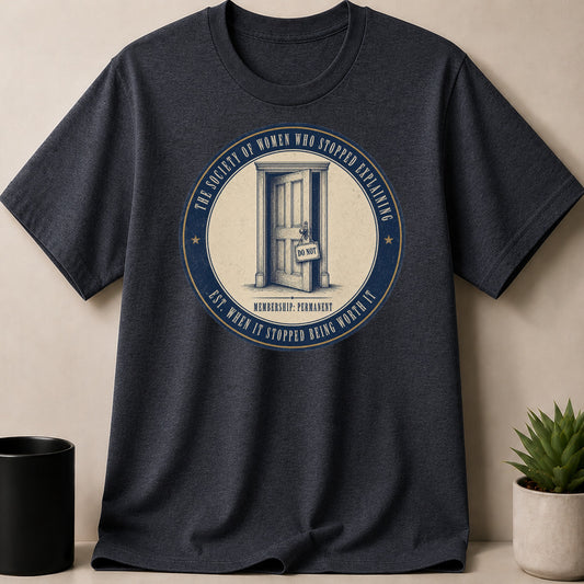 Dark t-shirt with circular graphic: "The Society of Women Who Stopped Explaining"