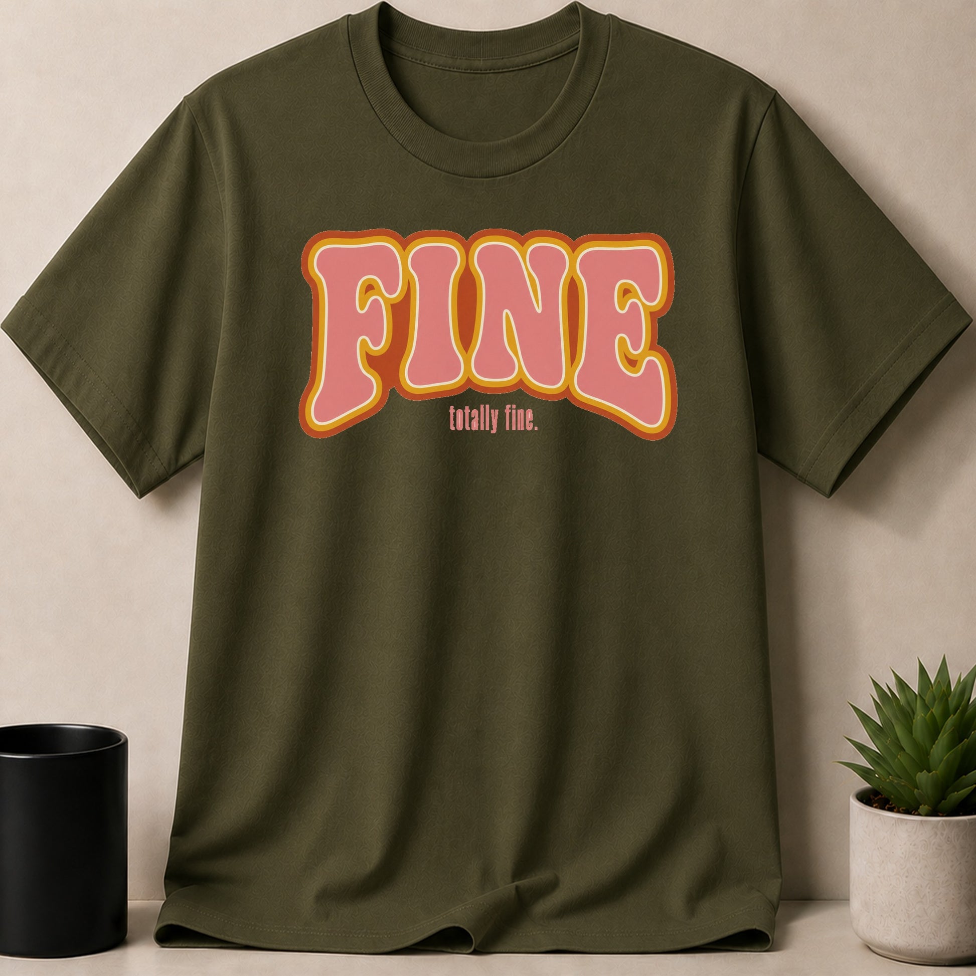 Green t-shirt with pink "FINE" text and "totally fine." below