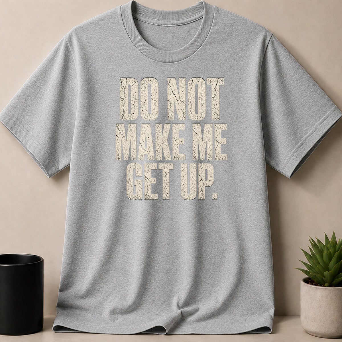 Gray t-shirt with distressed text "DO NOT MAKE ME GET UP."