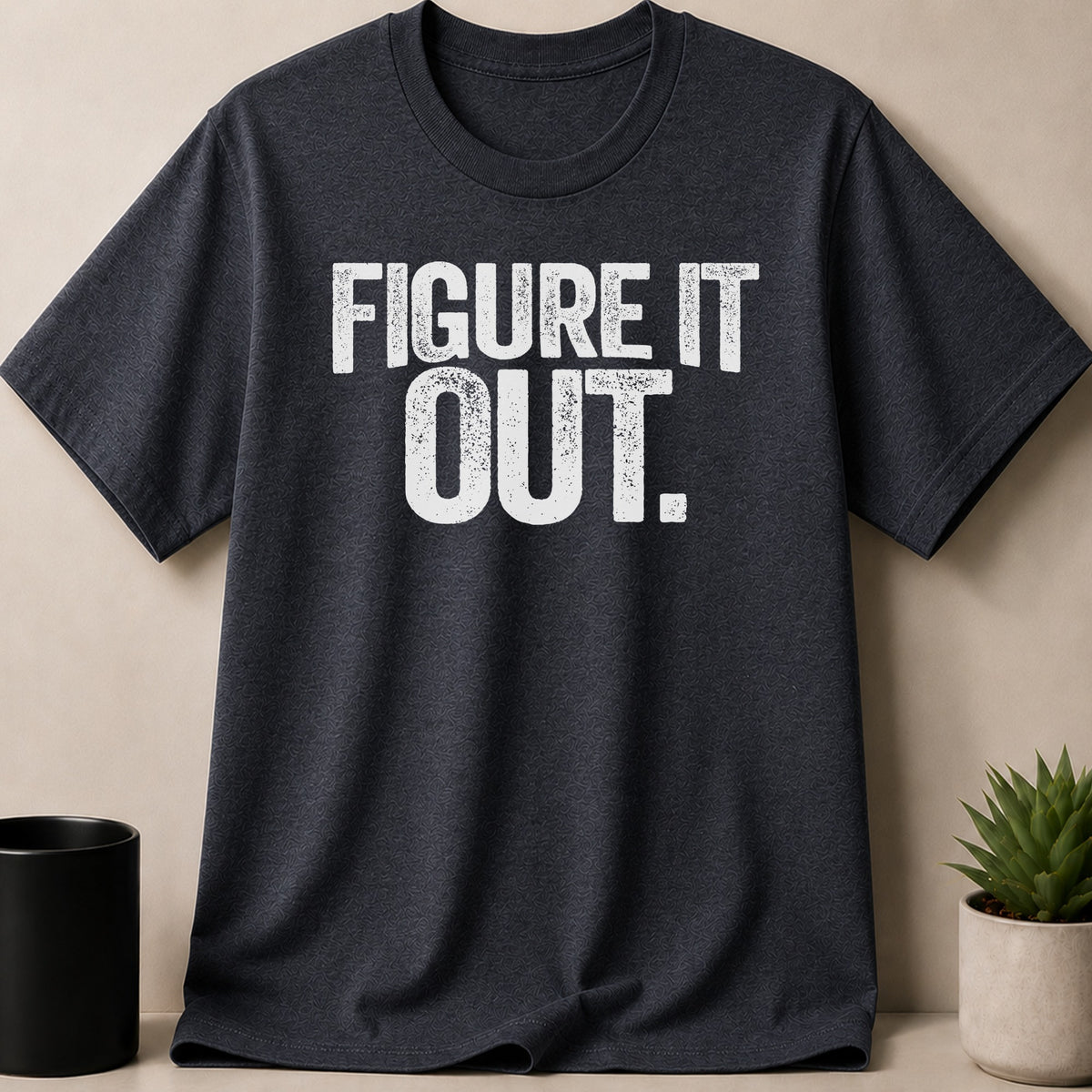 Dark grey t-shirt with white distressed text that reads "FIGURE IT OUT."