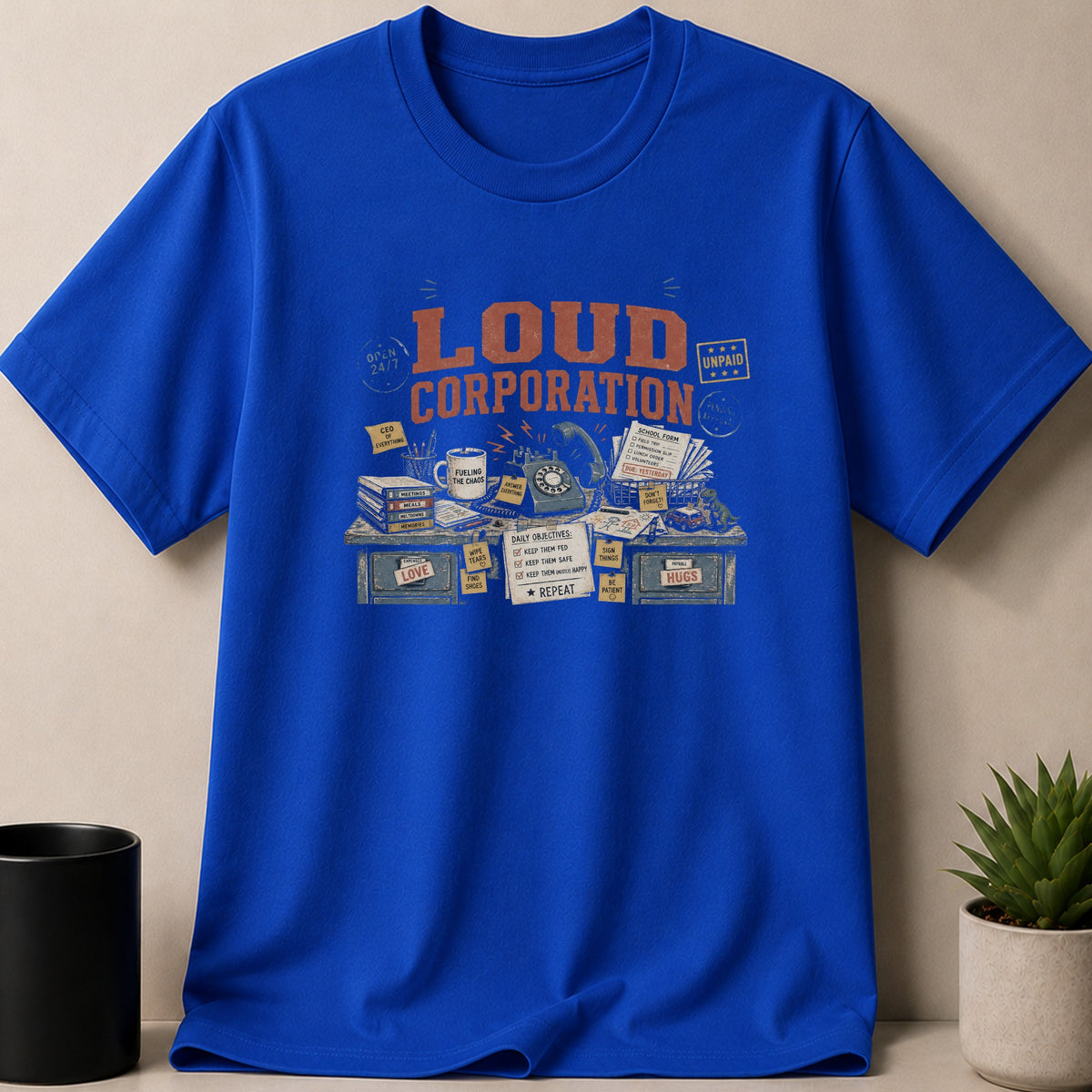 Blue t-shirt with "LOUD CORPORATION" and office desk graphic.