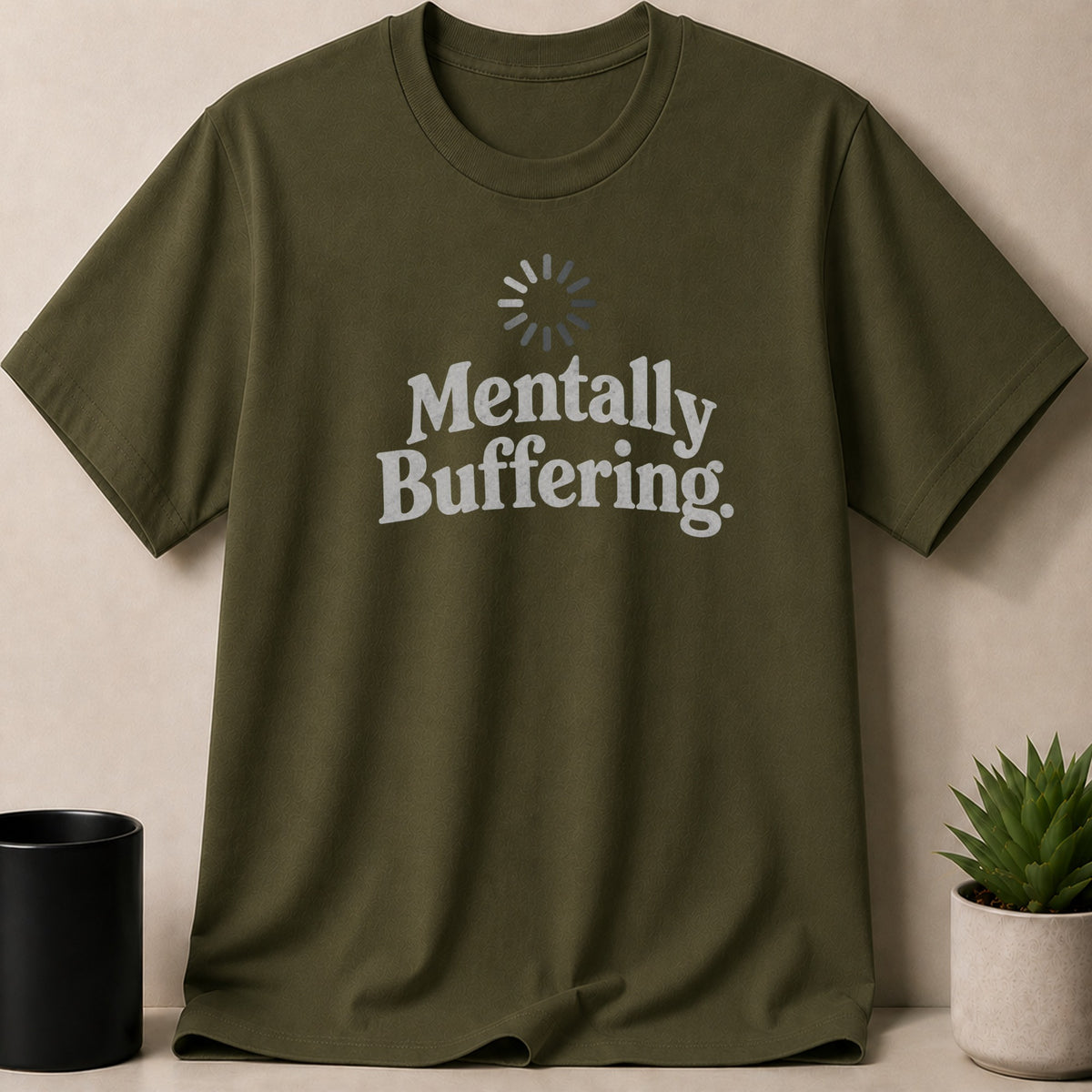 Olive green t-shirt with "Mentally Buffering" text and loading icon.