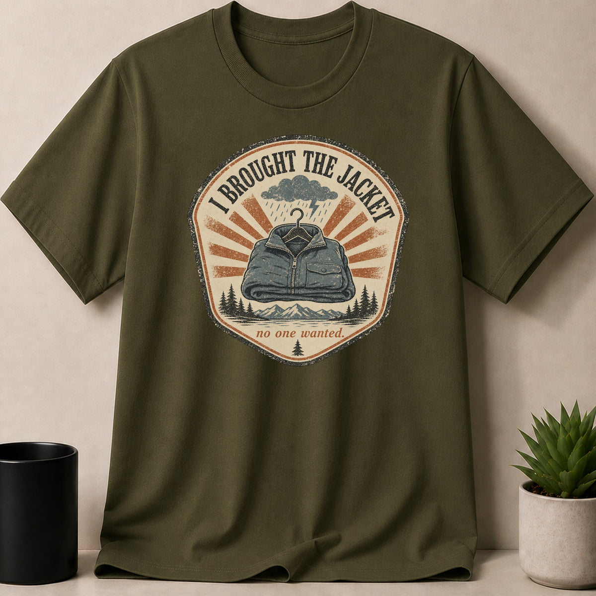 Olive green t-shirt with a circular graphic featuring a jacket.