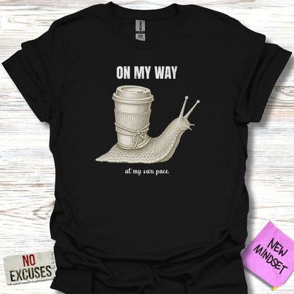 Black t-shirt with "ON MY WAY" and snail with coffee cup graphic.