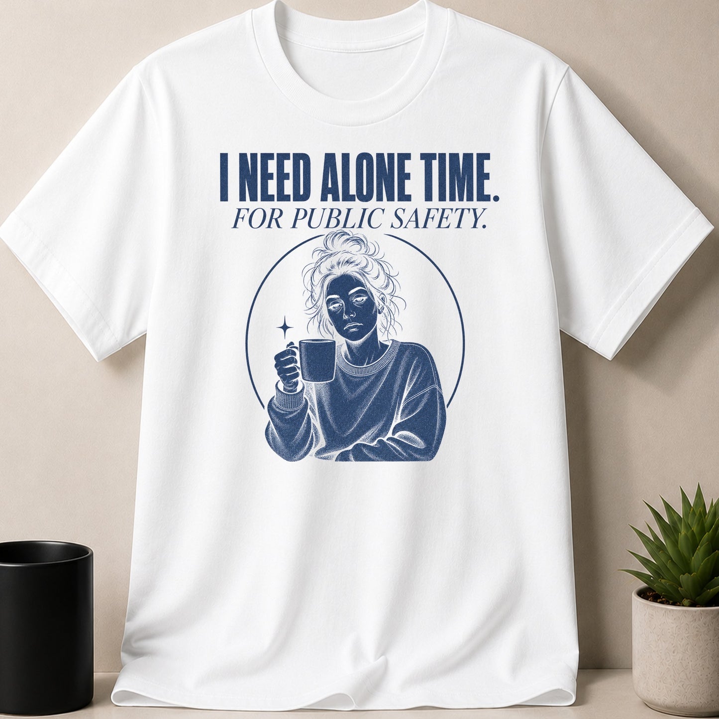 White t-shirt with blue text "I NEED ALONE TIME. FOR PUBLIC SAFETY." and a graphic.