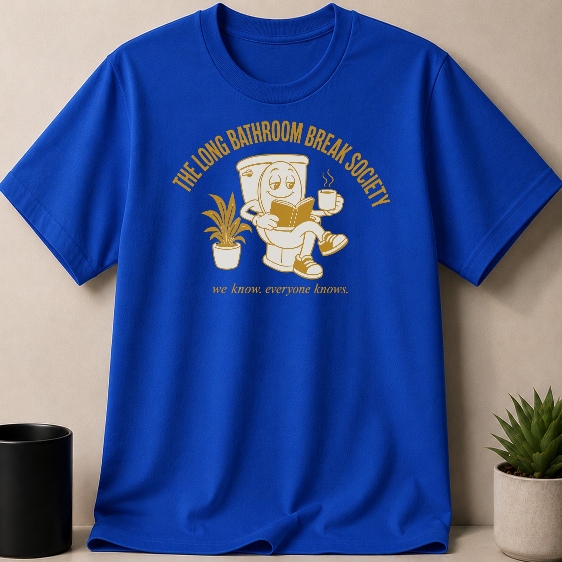 Royal blue t-shirt with a cartoon toilet reading and holding coffee.