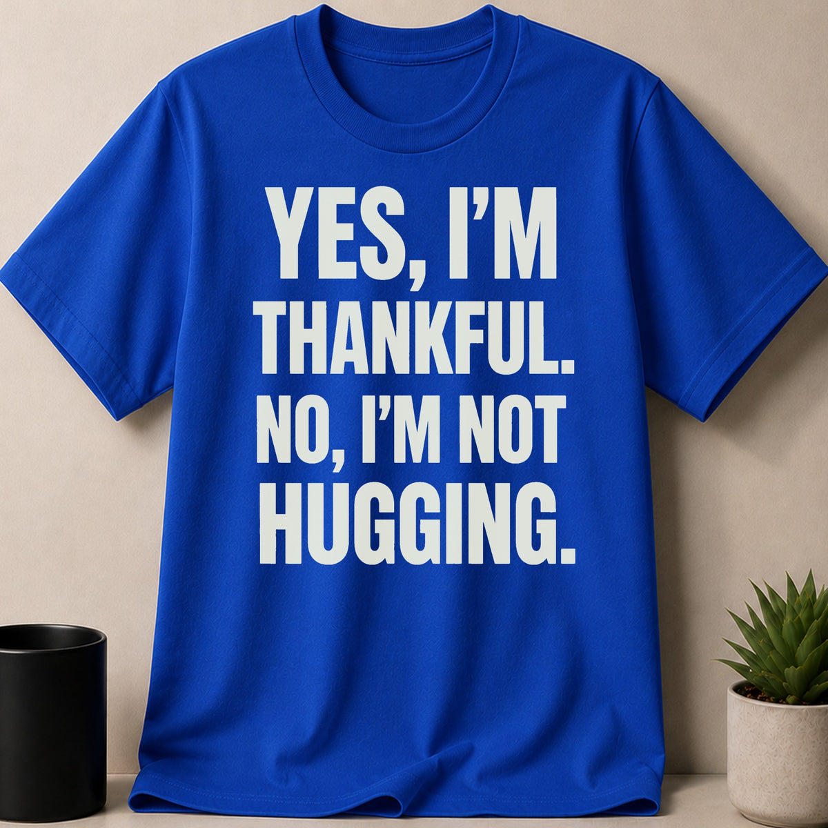 Blue t-shirt with white text: "YES, I'M THANKFUL. NO, I'M NOT HUGGING."