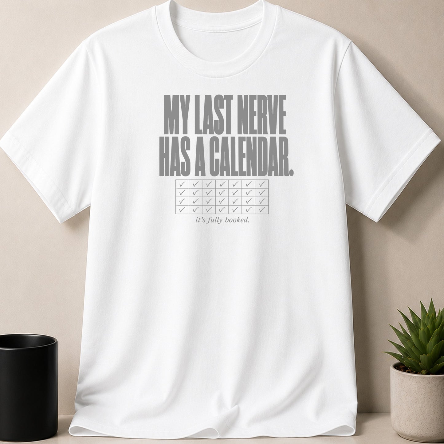 White t-shirt with "MY LAST NERVE HAS A CALENDAR. it's fully booked." text.