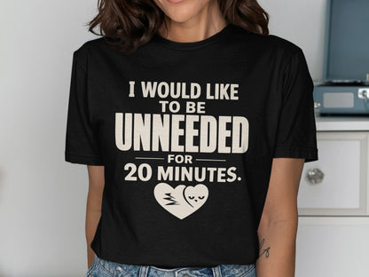 Black t-shirt with text "I WOULD LIKE TO BE UNNEEDED FOR 20 MINUTES." and heart graphic.