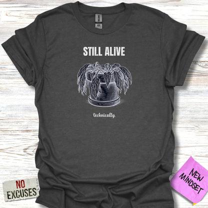 Dark grey t-shirt with potted plant graphic and text "STILL ALIVE technically."