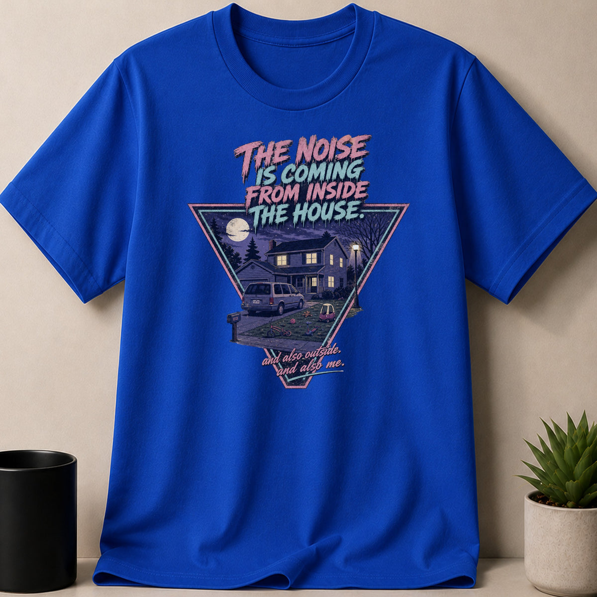 Blue t-shirt with "The Noise Is Coming From Inside The House." graphic.