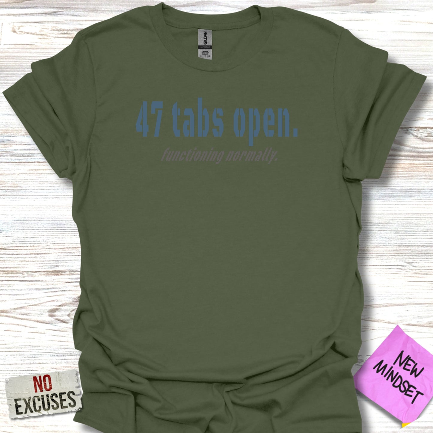 Green t-shirt with blue text "47 tabs open. functioning normally."