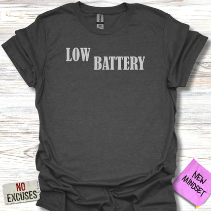 Dark grey t-shirt with white text "LOW BATTERY" and a "NEW MINDSET" sticker.