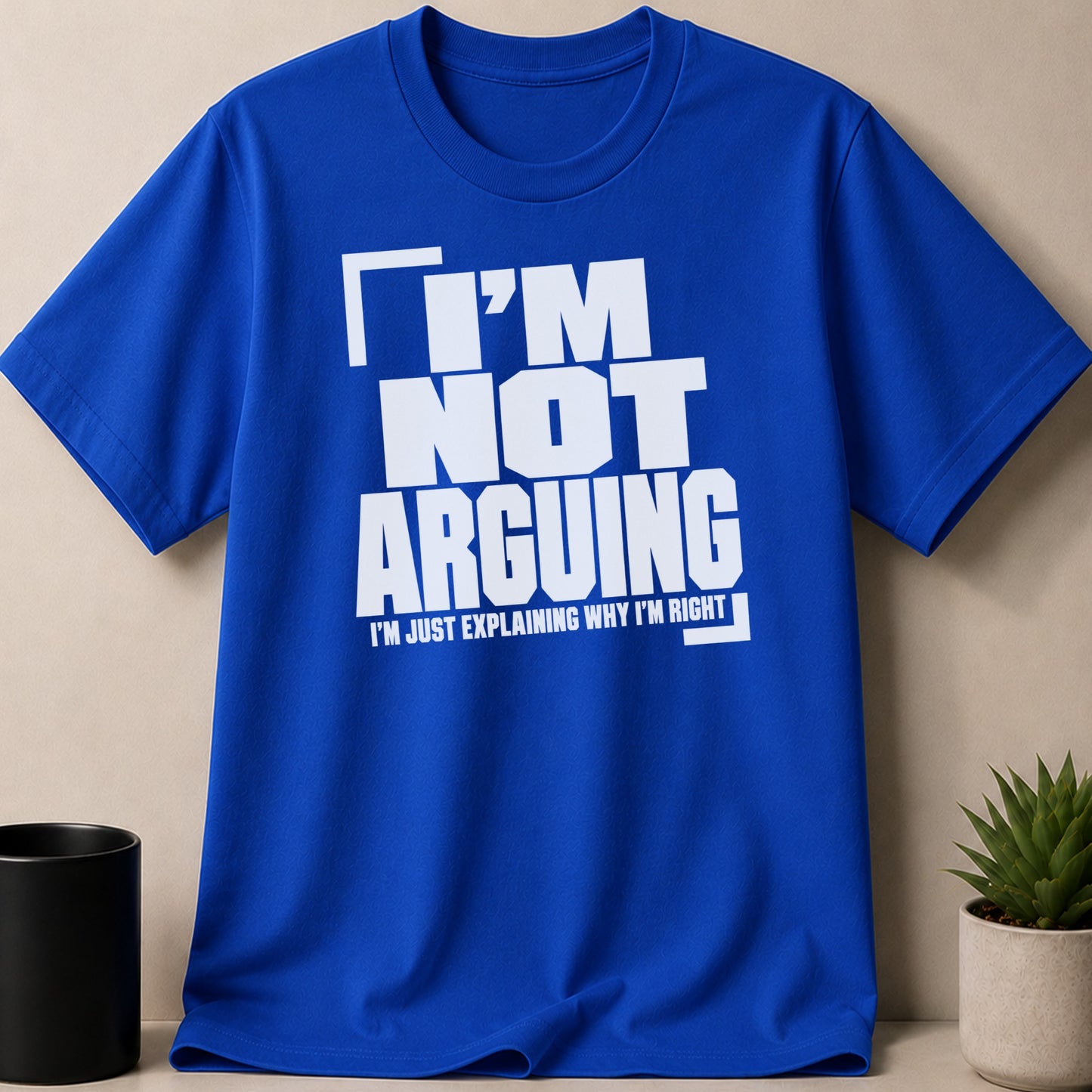 Royal blue t-shirt with white text "I'M NOT ARGUING I'M JUST EXPLAINING WHY I'M RIGHT".