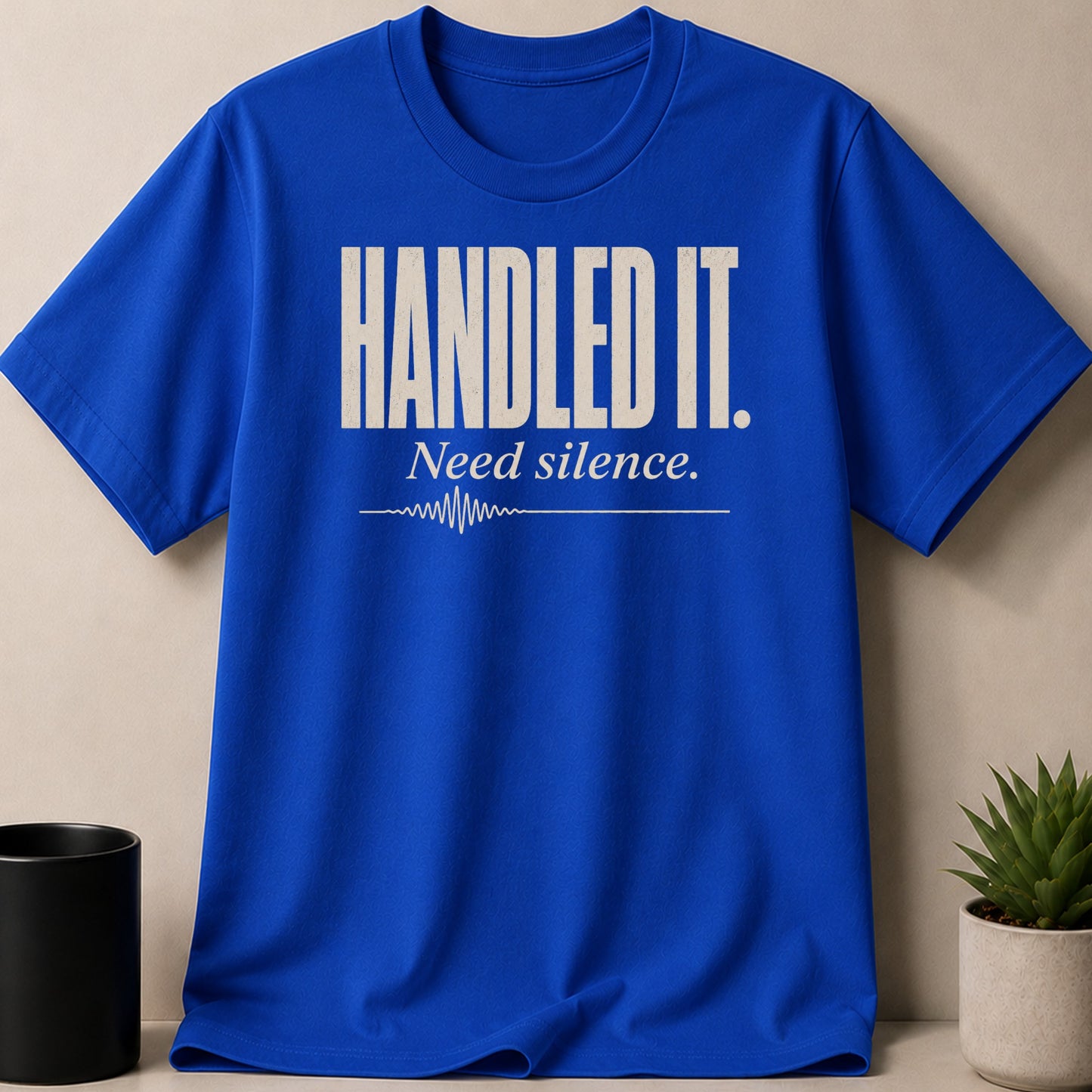 Blue t-shirt with "HANDLED IT. Need silence." text and heartbeat graphic.