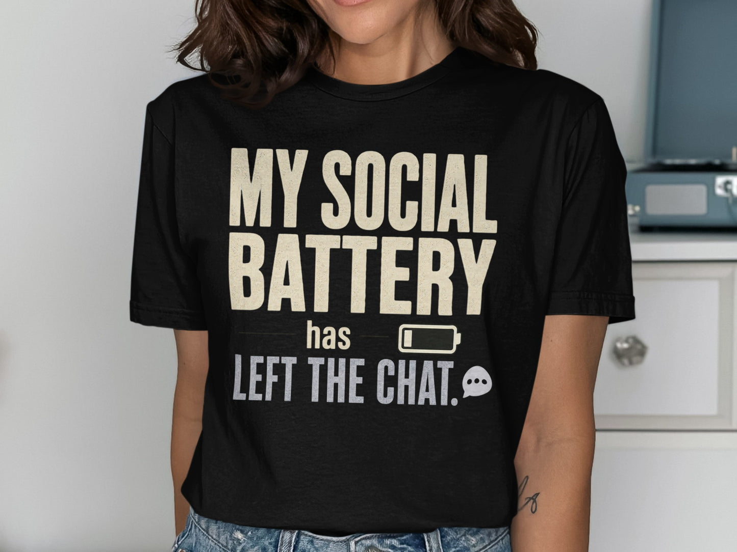 Black t-shirt with "MY SOCIAL BATTERY has left the chat" text and battery icon.