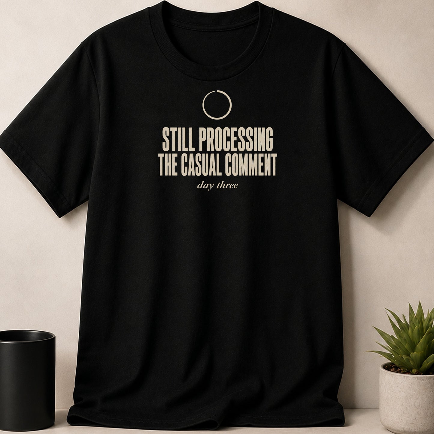 Black t-shirt with beige text "STILL PROCESSING THE CASUAL COMMENT day three".