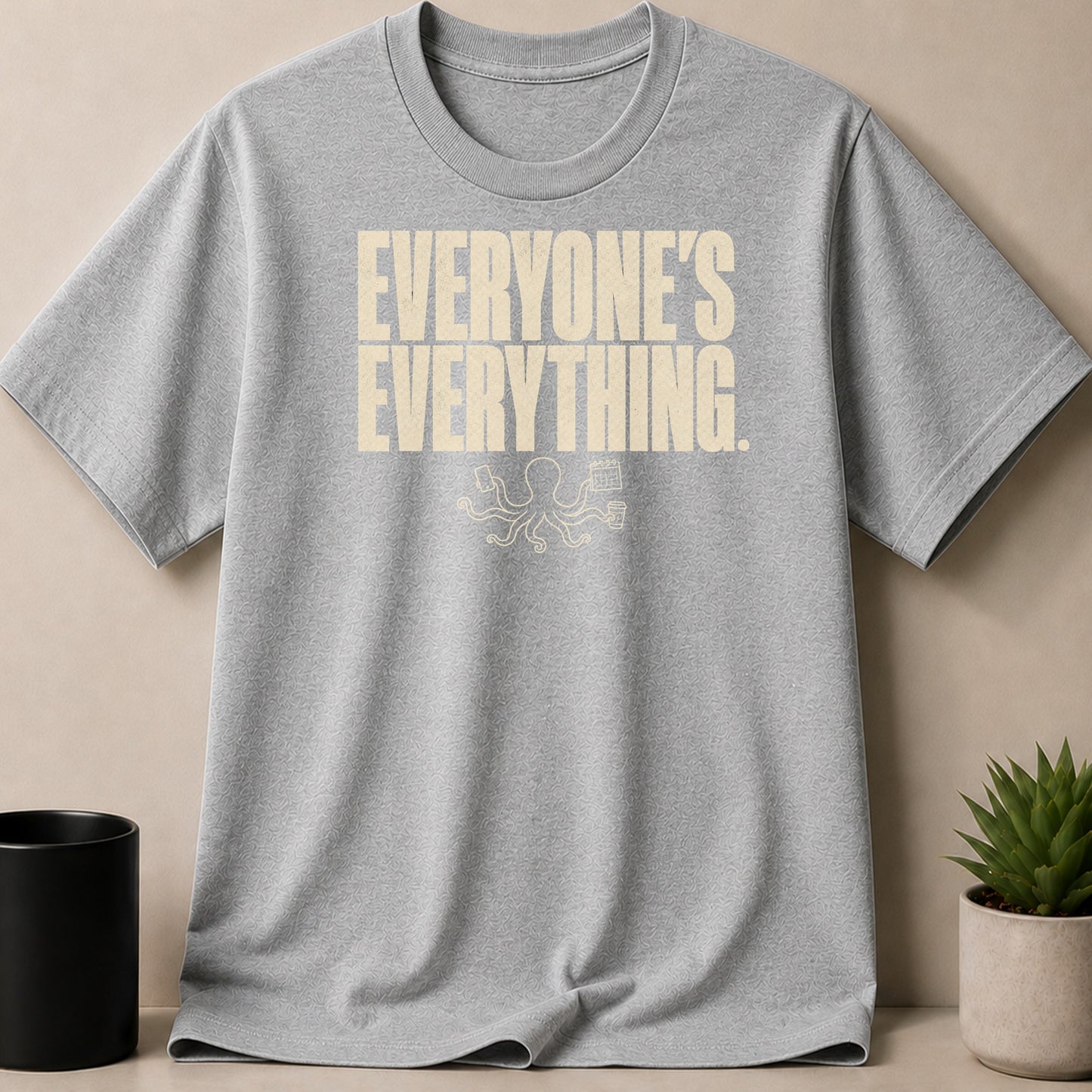 Grey t-shirt with "EVERYONE'S EVERYTHING" text and octopus graphic.
