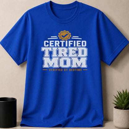 Blue t-shirt with "Certified Tired Mom Verified by Bedtime" text.