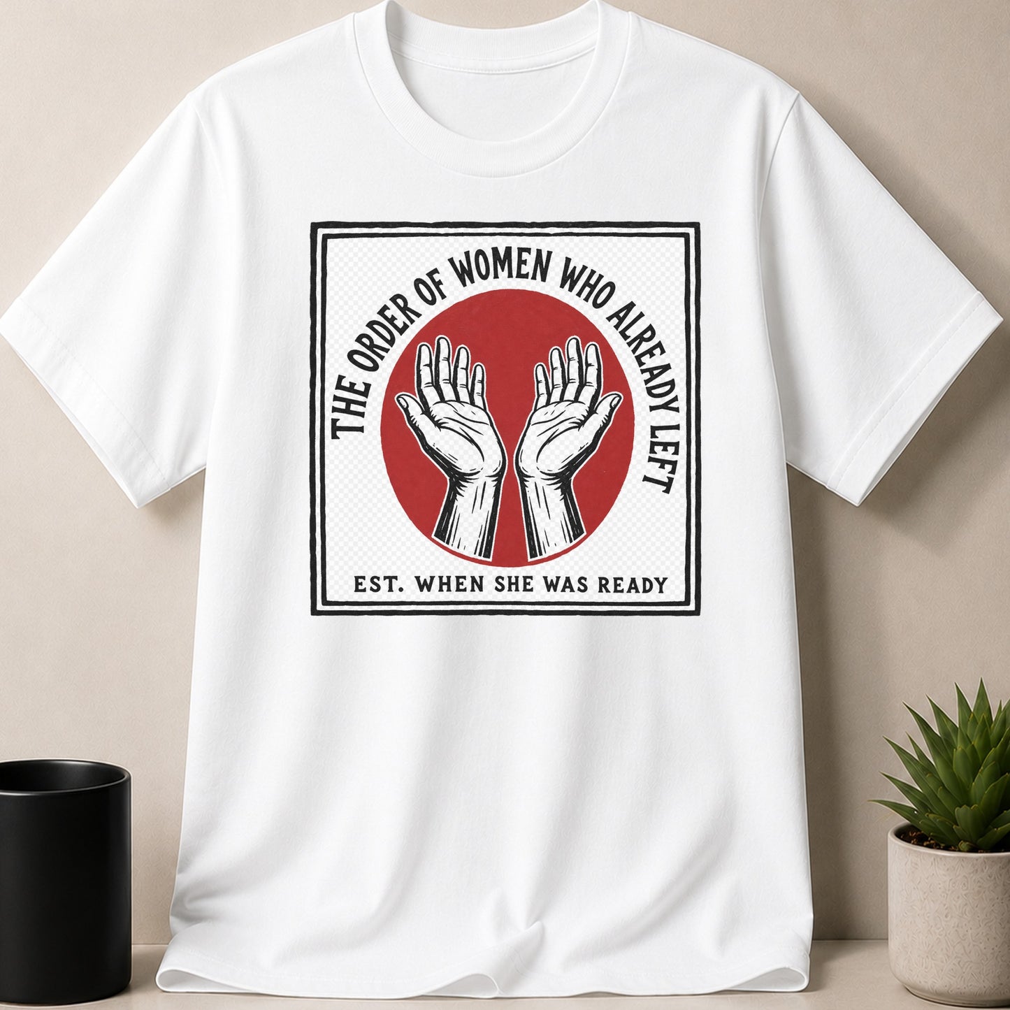 White t-shirt with graphic of hands, "The Order of Women Who Already Left" text.