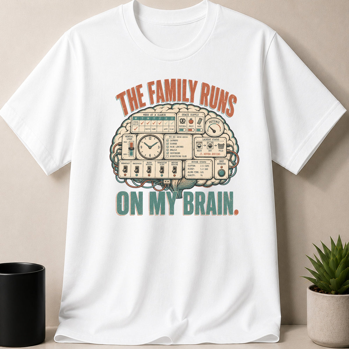 White t-shirt with graphic: "The Family Runs On My Brain," featuring a brain diagram of tasks and stats.
