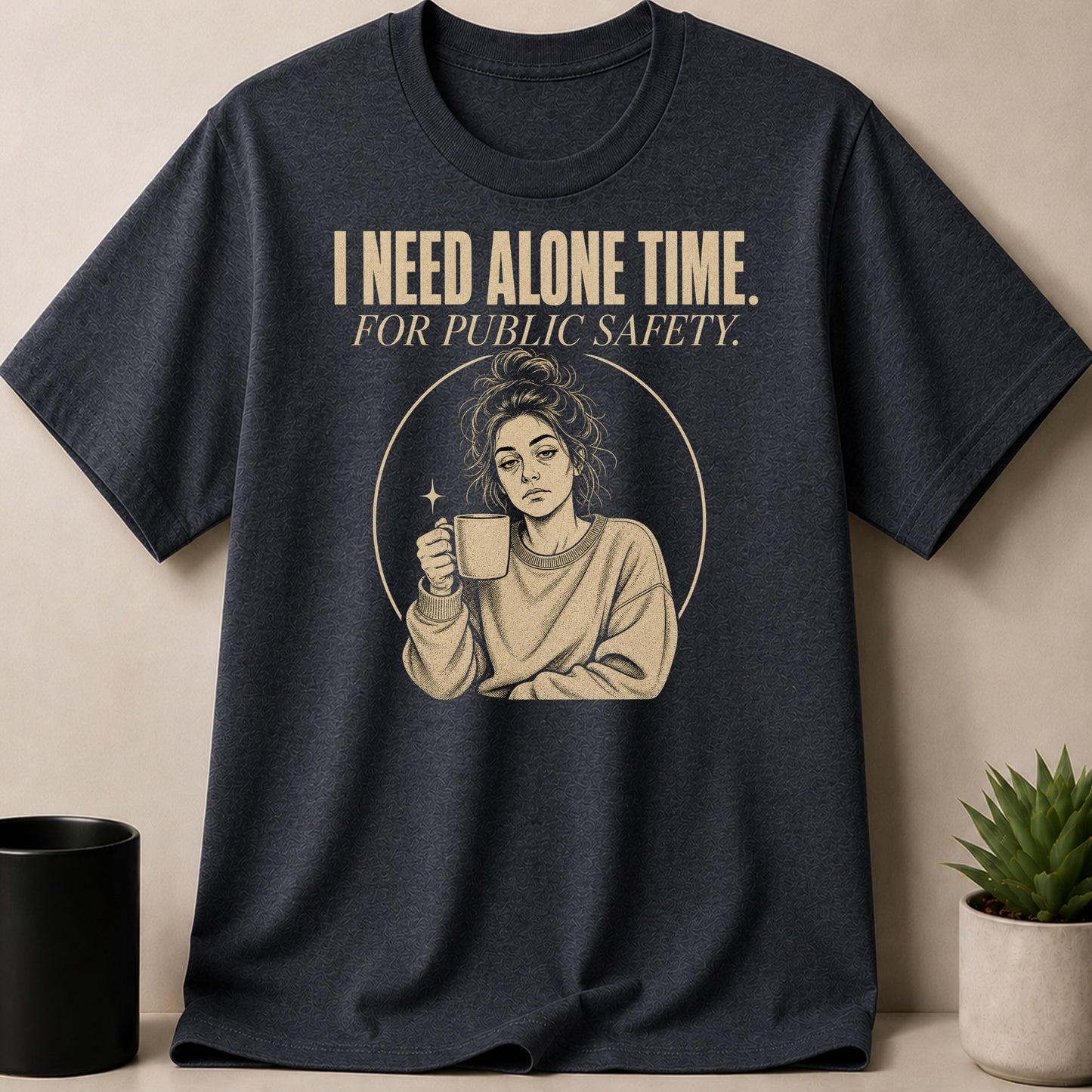 Dark grey t-shirt with text "I NEED ALONE TIME. FOR PUBLIC SAFETY." and illustration.