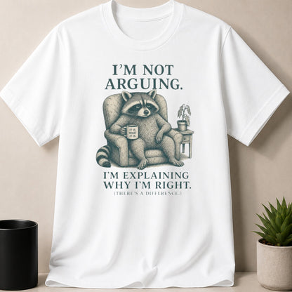 White t-shirt with a raccoon in a chair holding a mug, text reads "I'm not arguing."
