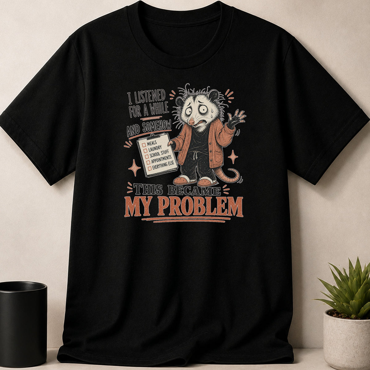 Black t-shirt with distressed graphic of a possum holding a checklist and the text "This Became My Problem".