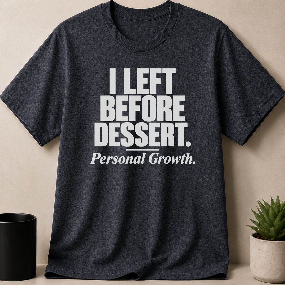 Dark grey t-shirt featuring the white text I LEFT BEFORE DESSERT and Personal Growth.
