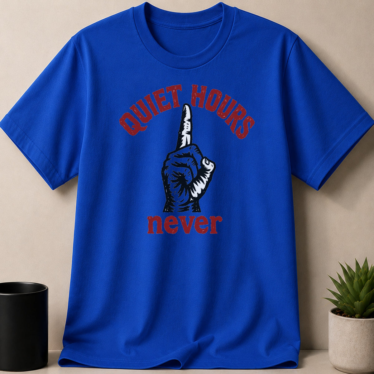 Royal blue t-shirt with red text "QUIET HOURS" above a black and white finger graphic and "never."