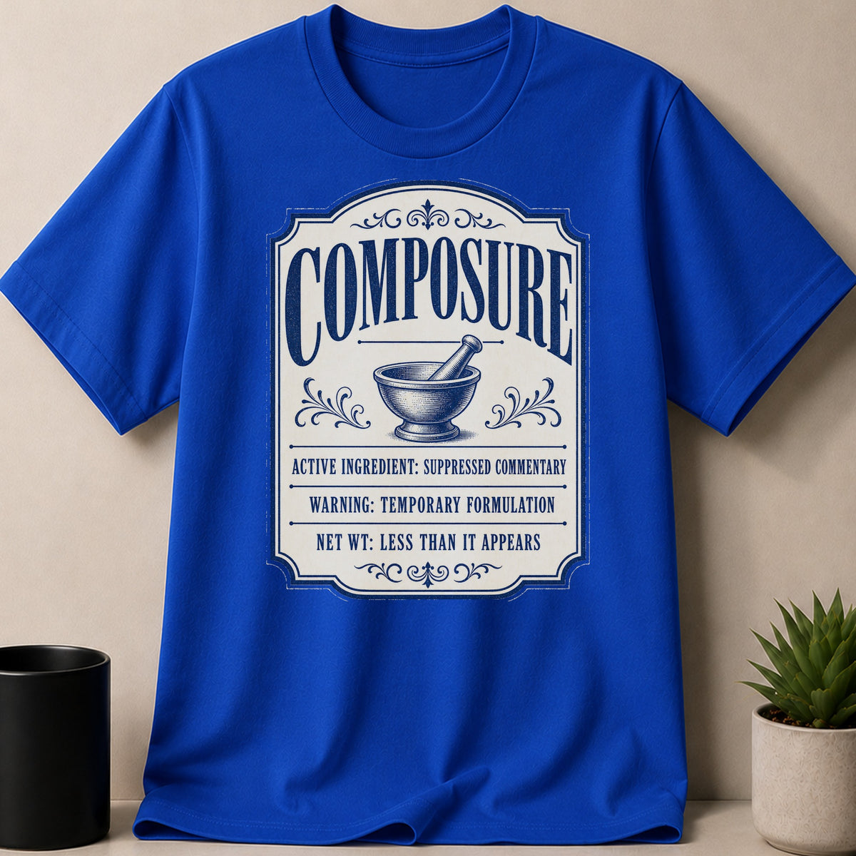 Royal blue t-shirt with "Composure" label design featuring mortar and pestle.