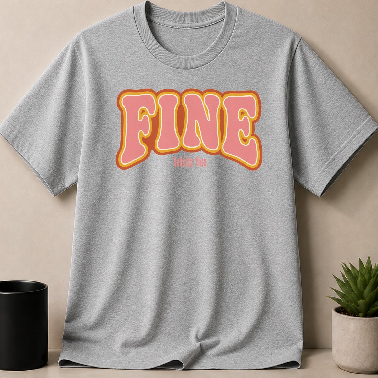 Grey t-shirt with "FINE" in wavy pink and orange lettering.