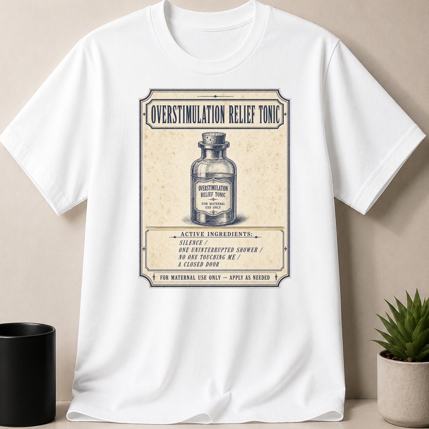 White t-shirt with "Overstimulation Relief Tonic" label, listing active ingredients, for maternal use.