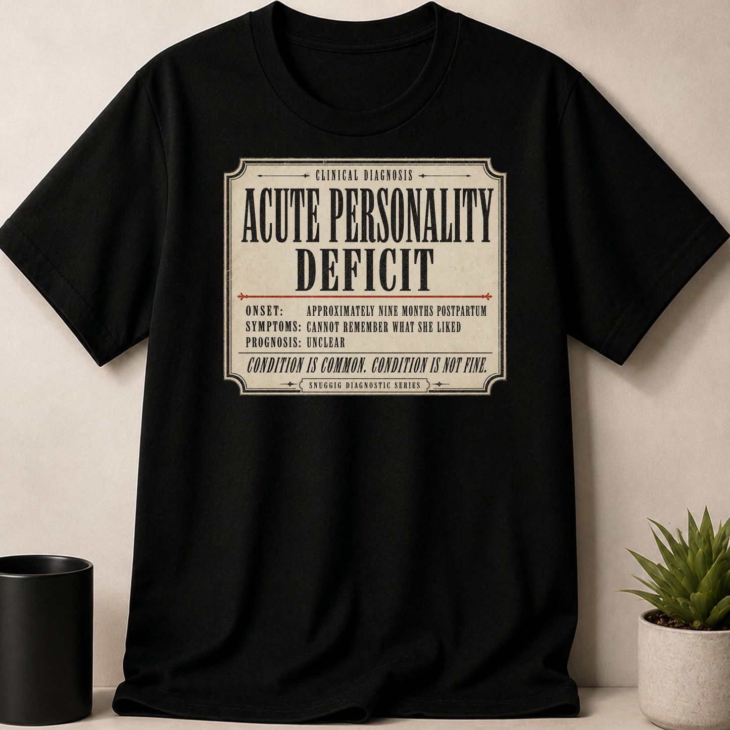Black t-shirt with a distressed label reading "Acute Personality Deficit" and diagnostic details.