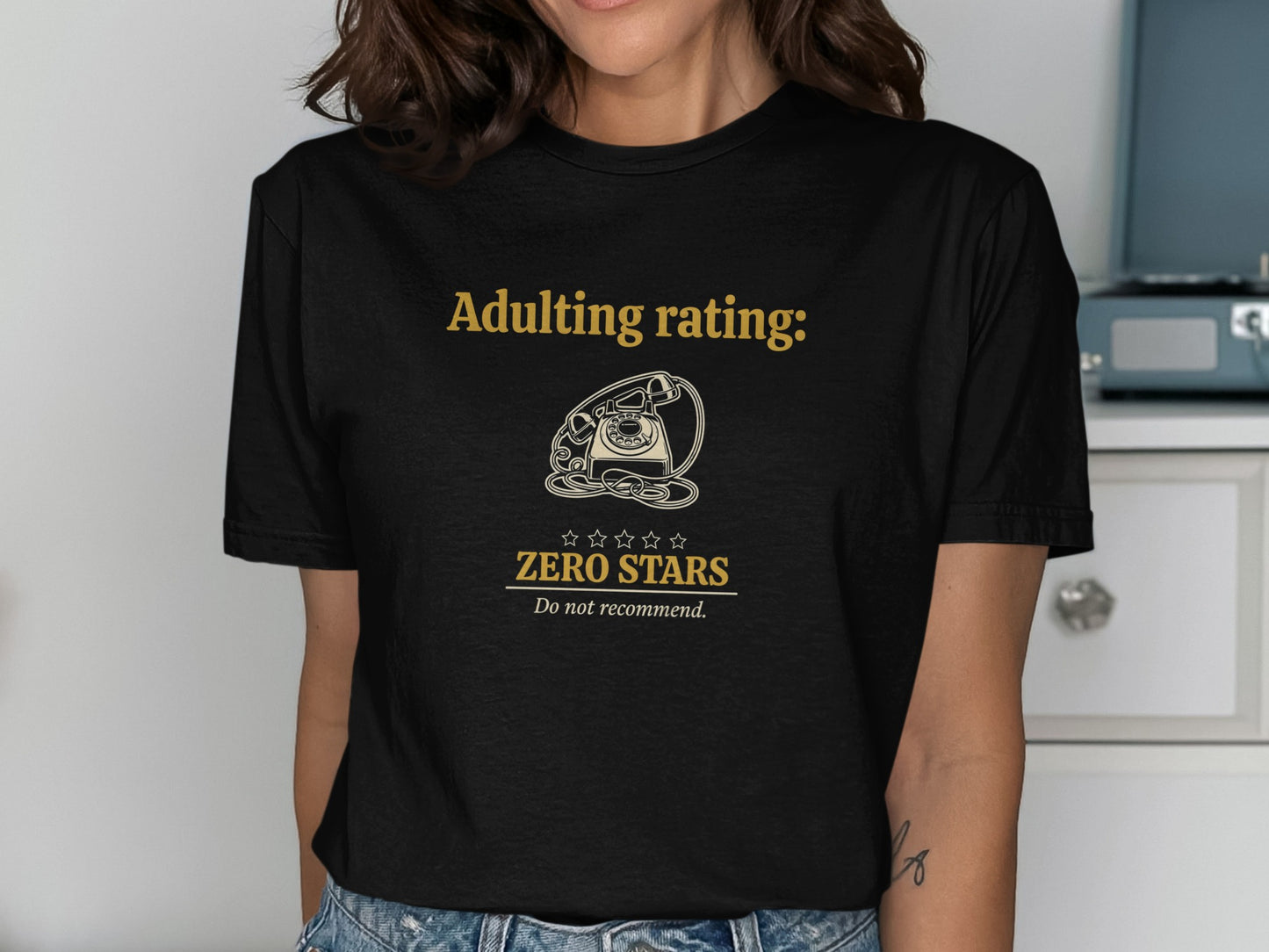 Black t-shirt with gold text "Adulting rating: Zero Stars, Do not recommend."