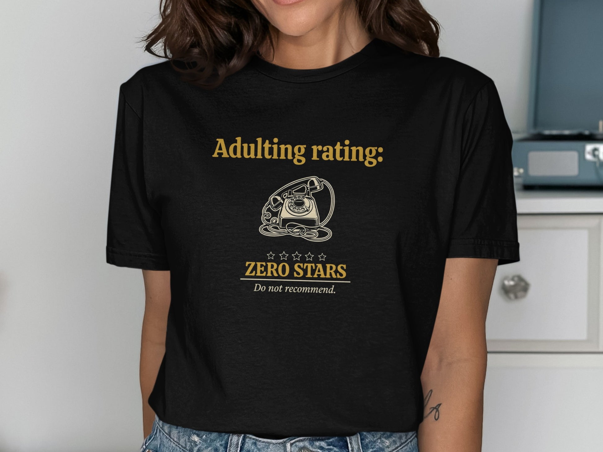Black t-shirt with gold text "Adulting rating: Zero Stars, Do not recommend."
