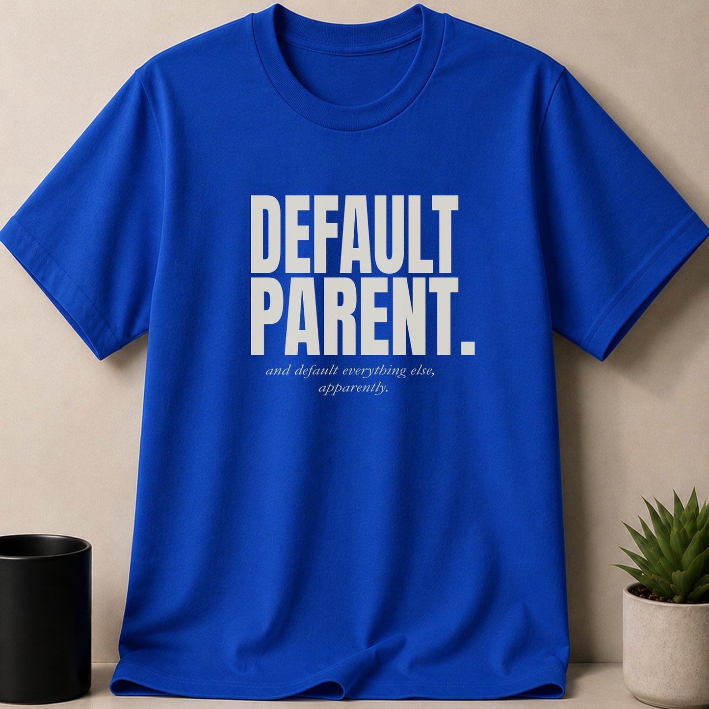 Blue t-shirt with "DEFAULT PARENT, and default everything else, apparently." text.