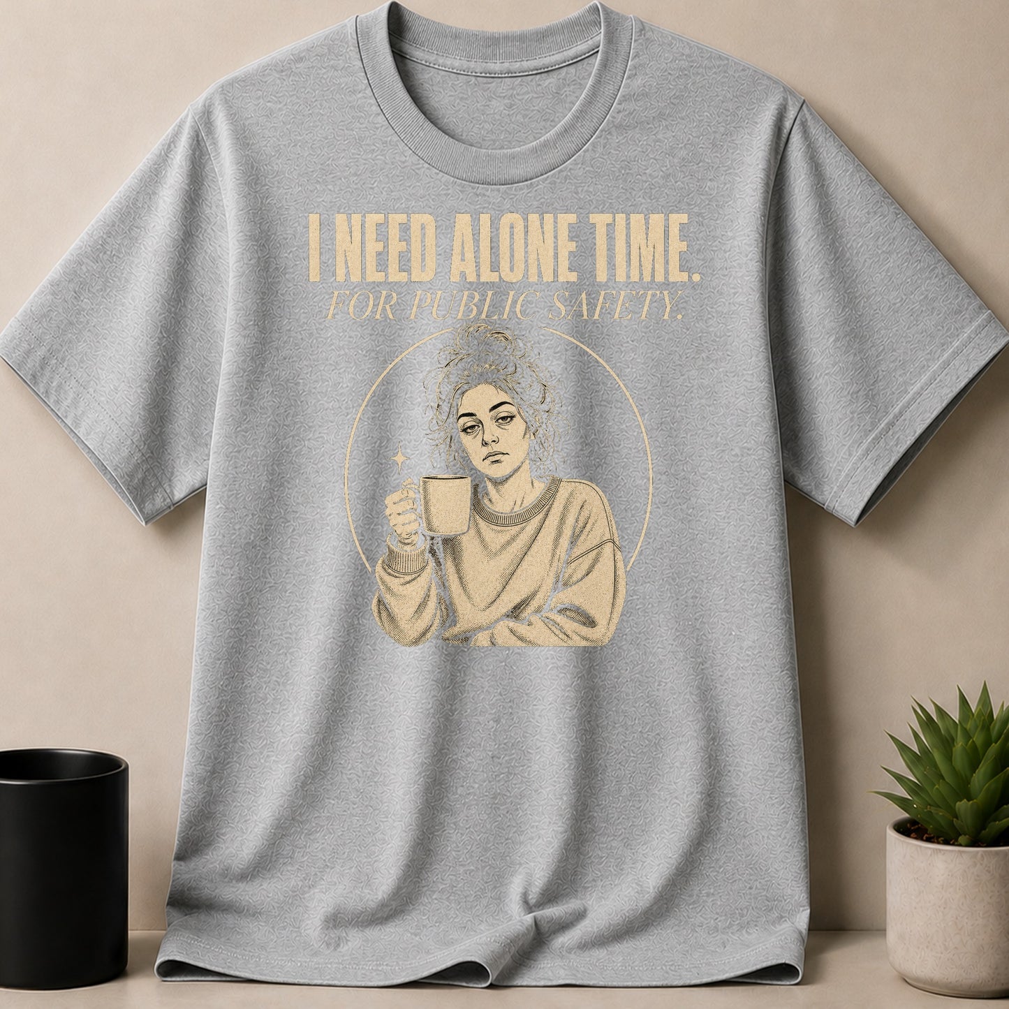 Grey t-shirt with "I NEED ALONE TIME. FOR PUBLIC SAFETY." text and graphic.