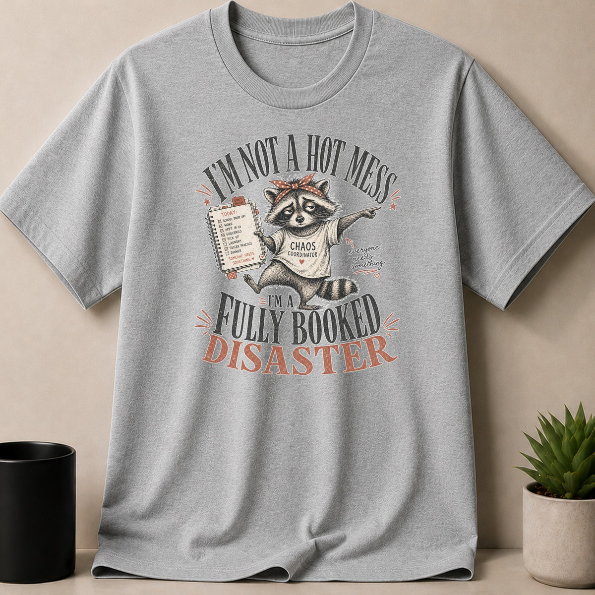 Gray t-shirt with a raccoon wearing a bandana and "CHAOS COORDINATOR" shirt.