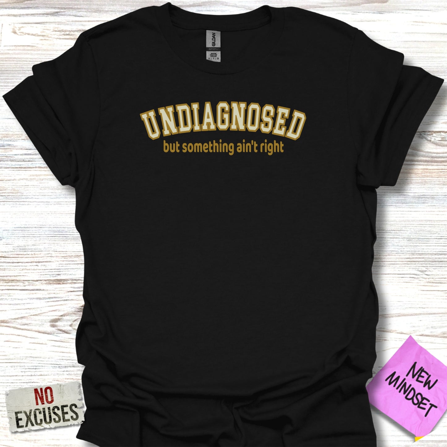 Black t-shirt with "UNDIAGNOSED but something ain't right" text.