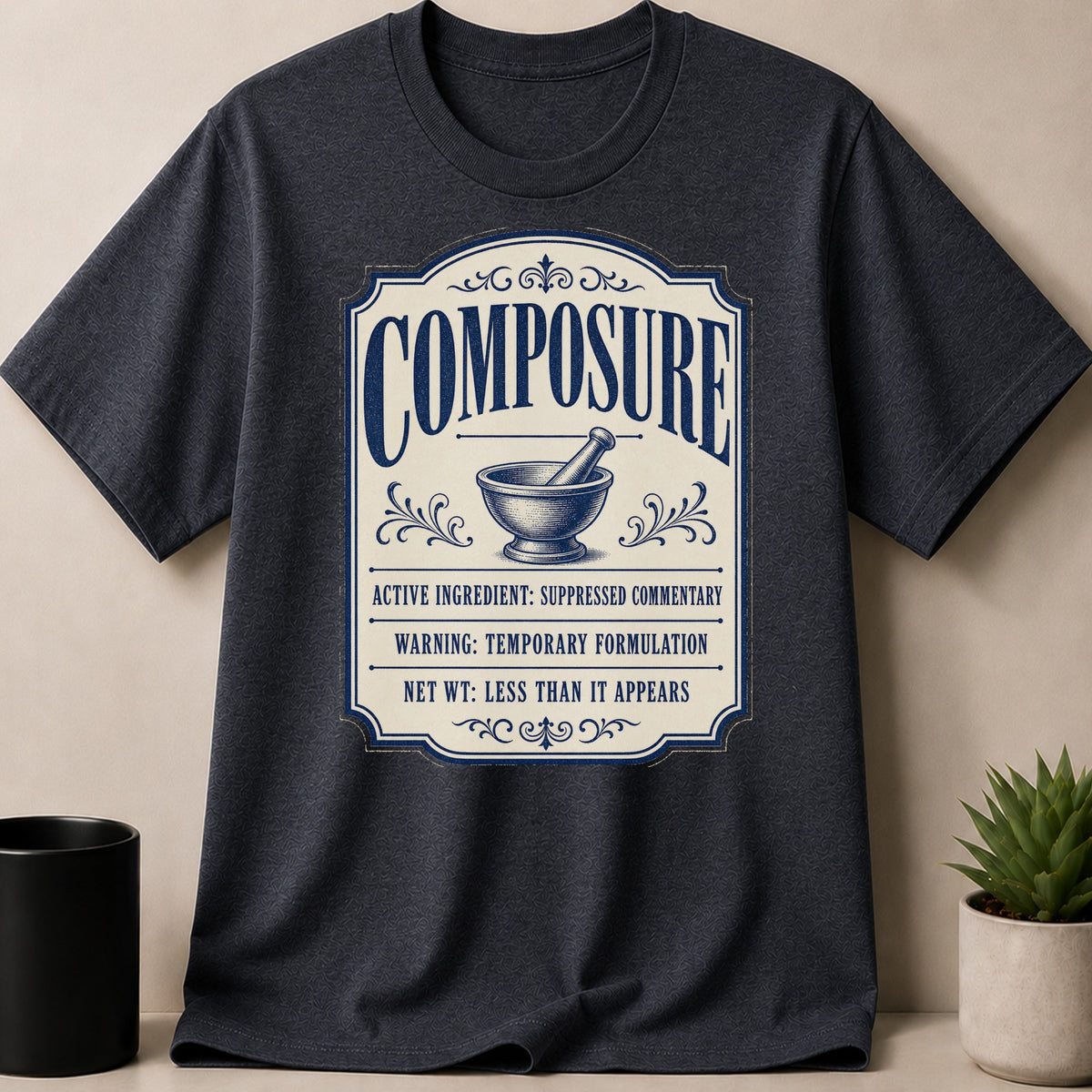 Dark gray t-shirt with "Composure" label, mortar and pestle graphic, and humorous text.