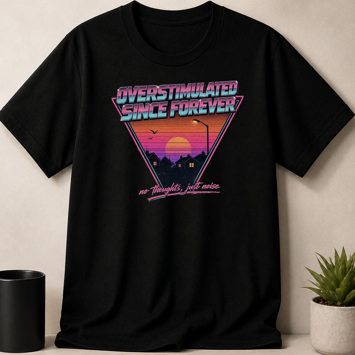 Black t-shirt with retro sunset graphic and text "Overstimulated Since Forever" and "no thoughts, just noise".