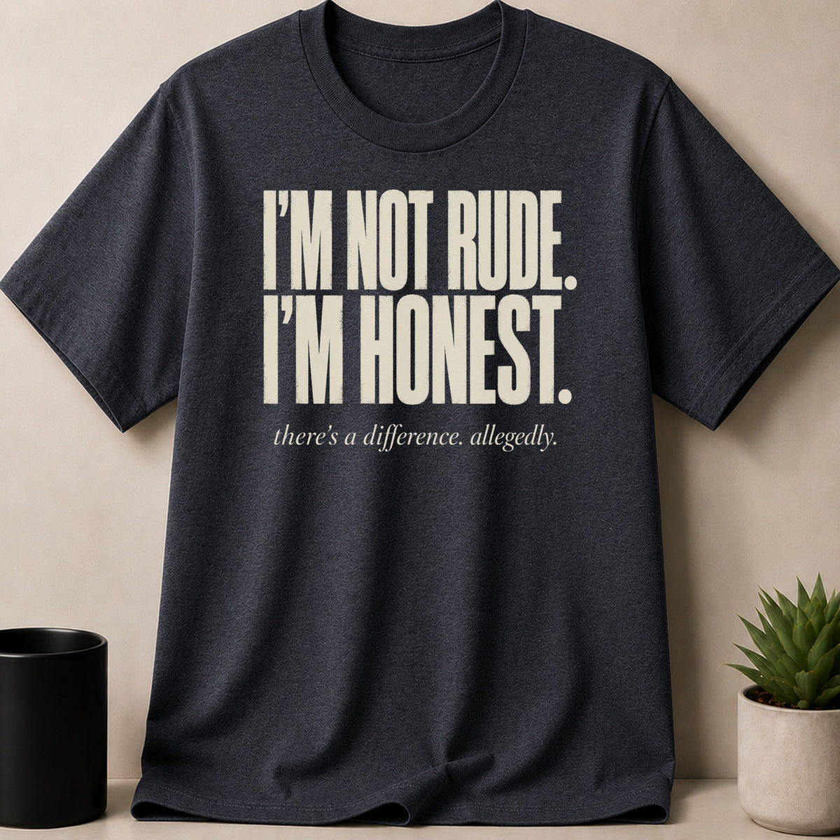 Dark grey t-shirt with white text: "I'M NOT RUDE. I'M HONEST. there's a difference. allegedly."