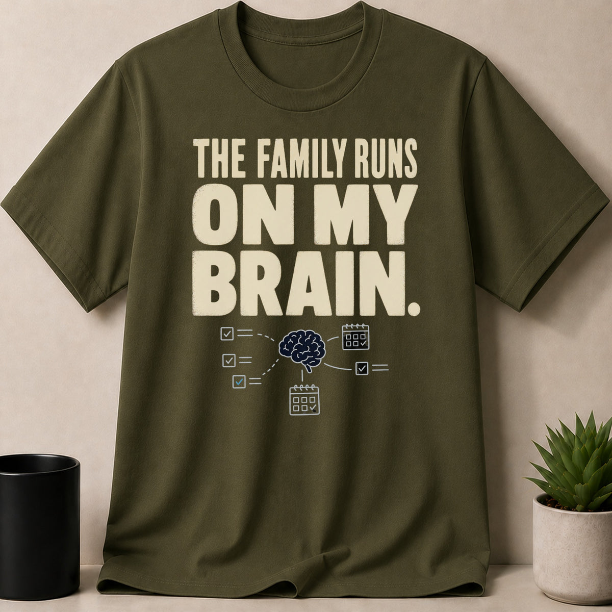 Olive green t-shirt with "The family runs on my brain" text and brain graphic.