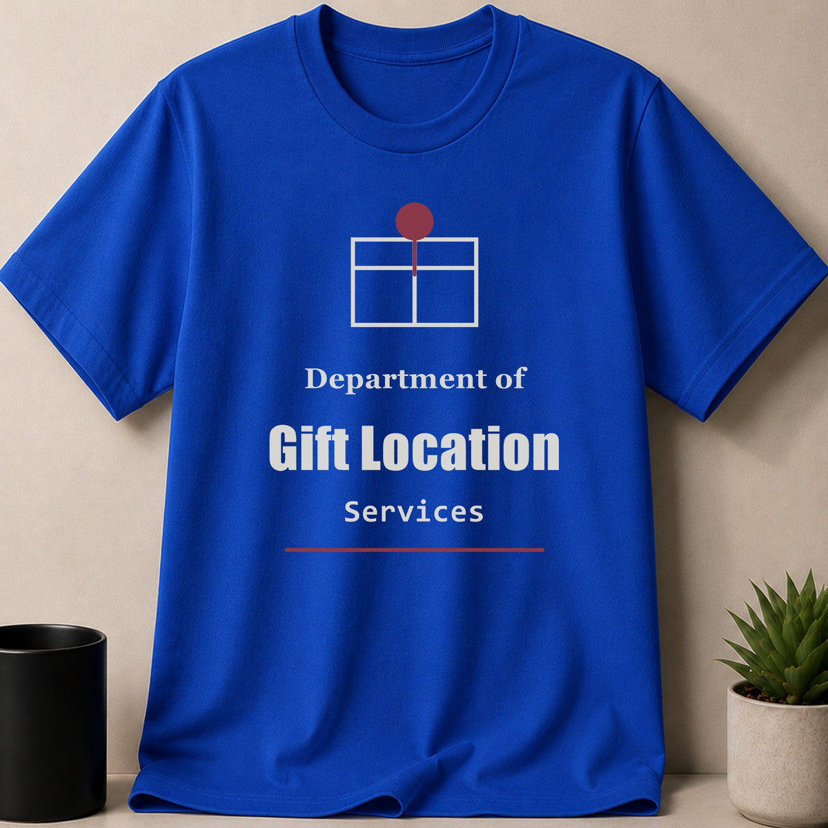 A royal blue t-shirt printed with the text Department of Gift Location Services and a gift icon.