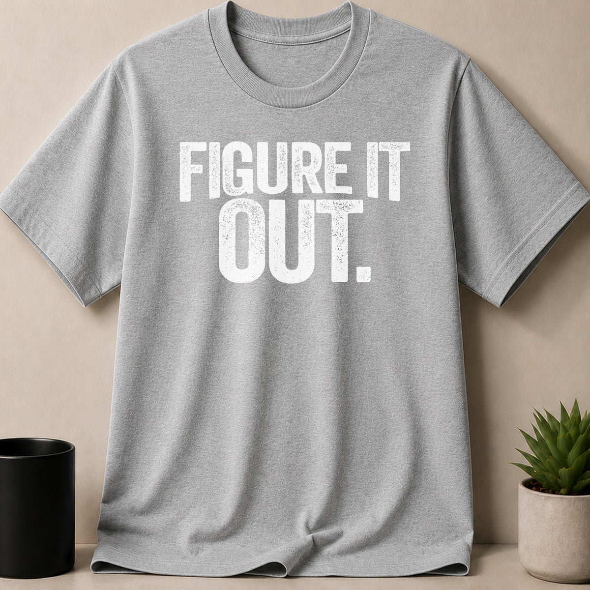 Grey t-shirt with white text that reads "FIGURE IT OUT."
