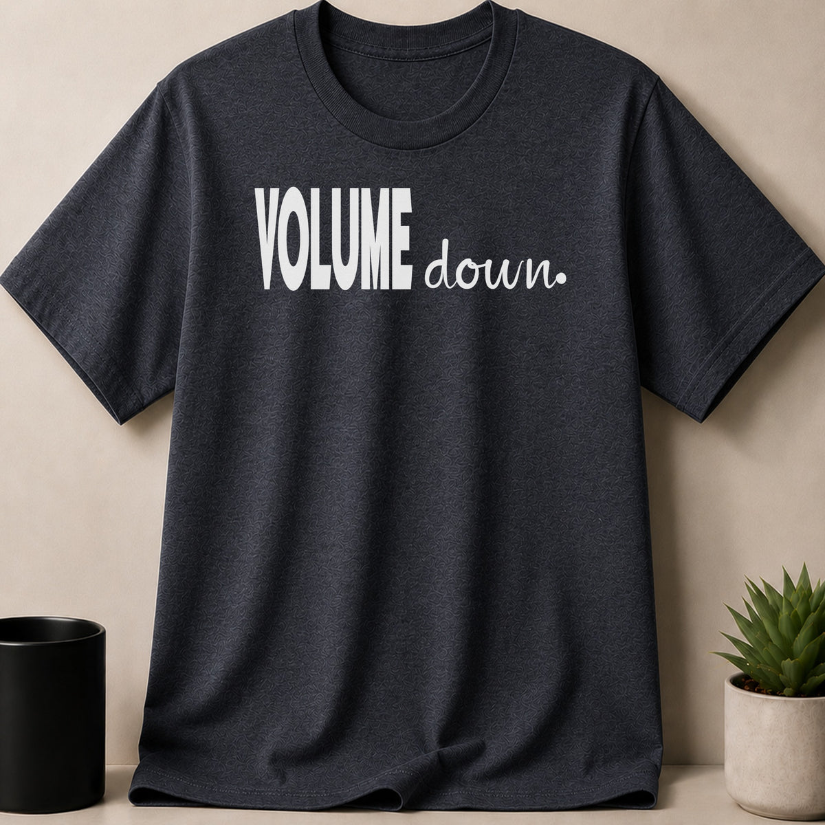 Dark grey t-shirt with white text "VOLUME down."