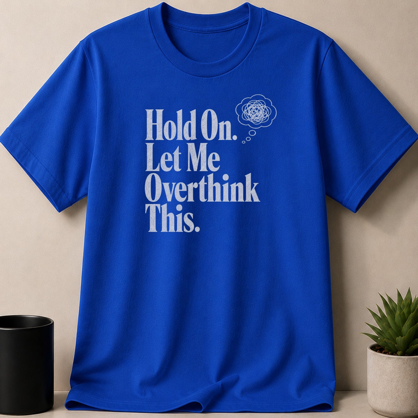 Blue t-shirt with white text "Hold On. Let Me Overthink This." and bubble graphic.
