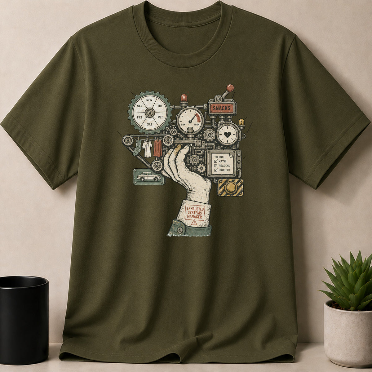 Green t-shirt with graphic of a complex machine, hand, and text "EXHAUSTED SYSTEMS MANAGER".