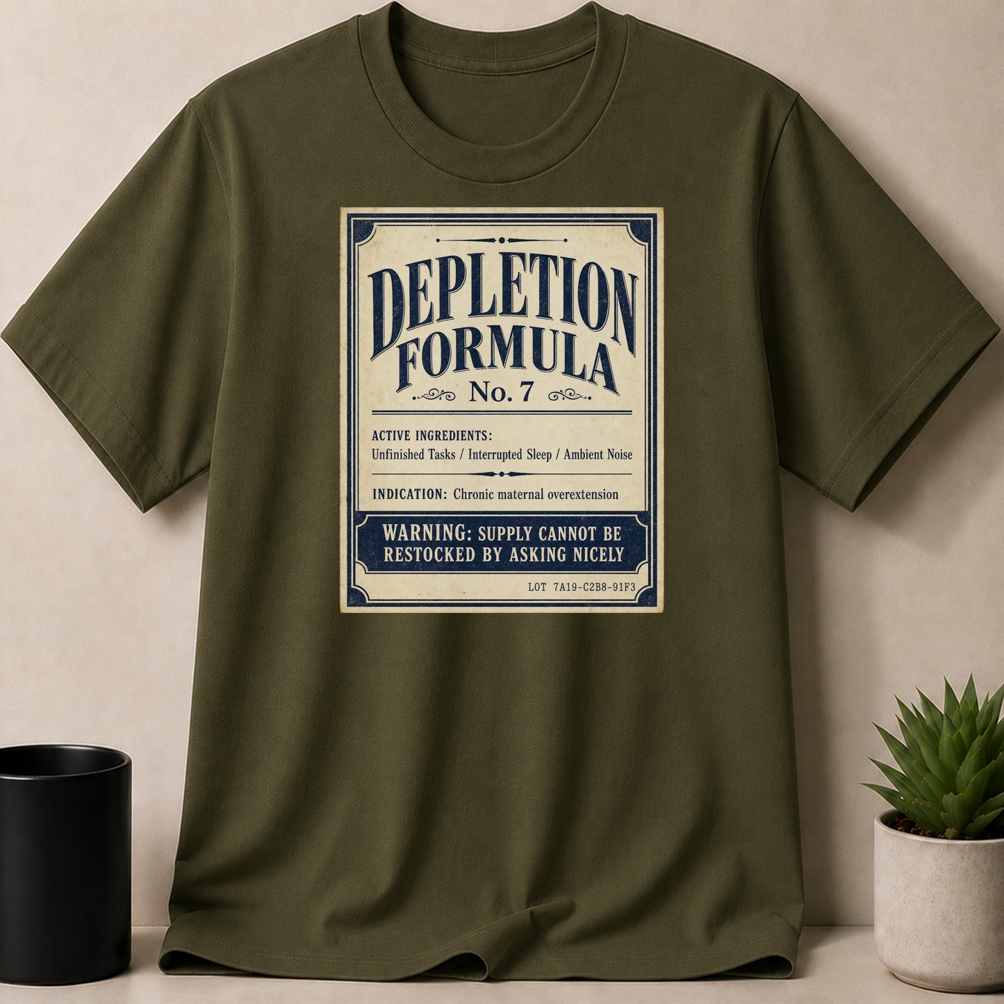 Green t-shirt with "Depletion Formula No. 7" design about maternal overextension.
